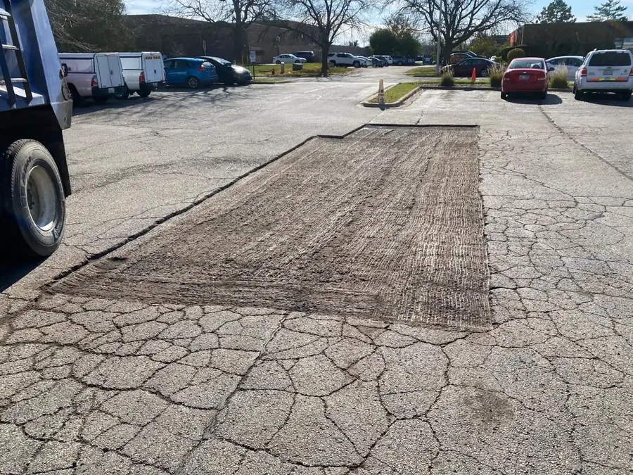 Alligator cracked section cut out down to the base for a patch, asphalt repair