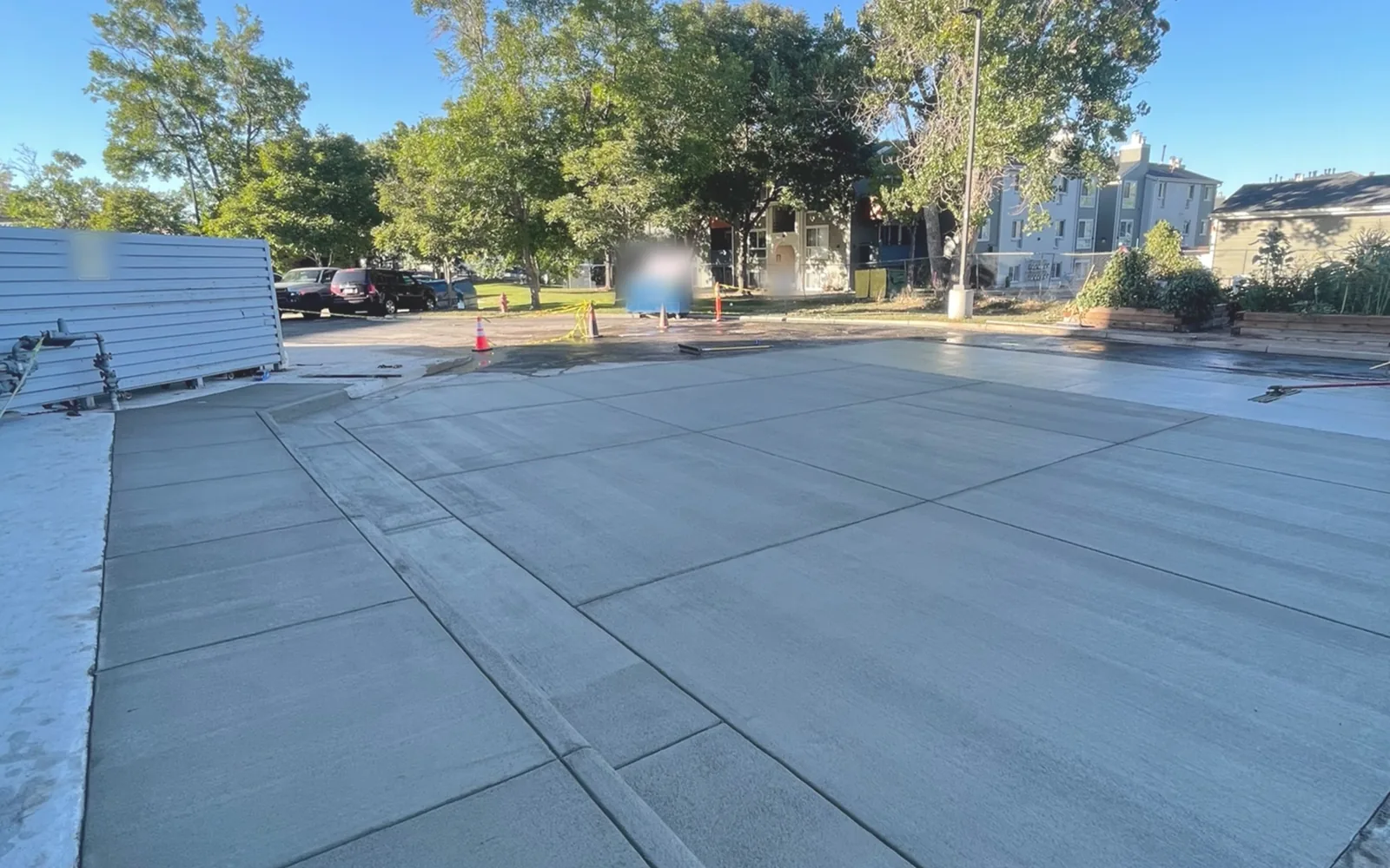 Large new concrete flatwork slab with tooled control joints at an apartment complex, concrete contractor flatwork
