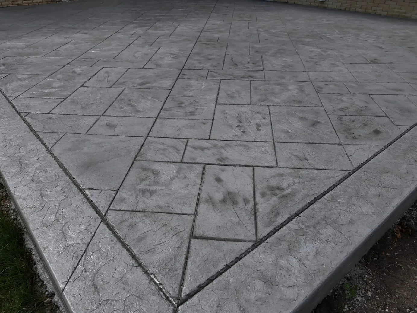 Stamped ashlar slate pattern with a border band, concrete patios