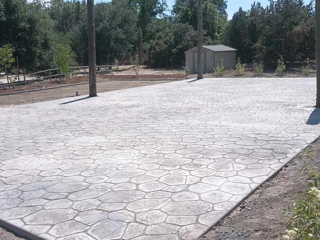 Stamped flagstone pattern patio in a rural yard, concrete patios