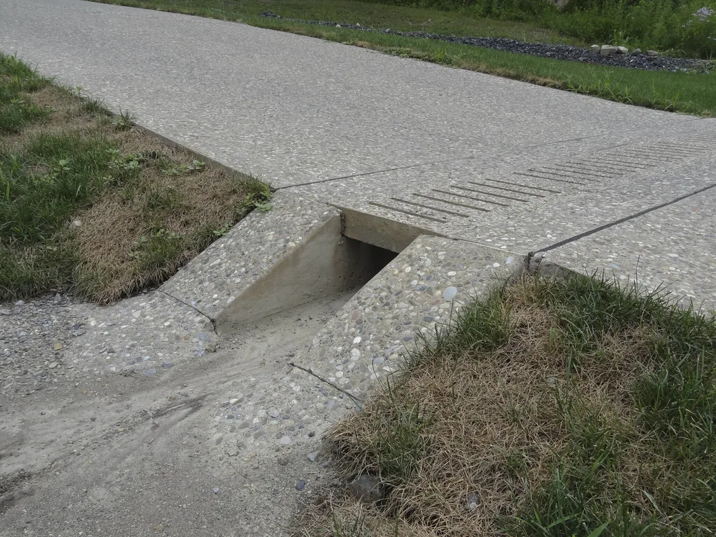 Driveway culvert crossing with a concrete headwall, grading drainage work