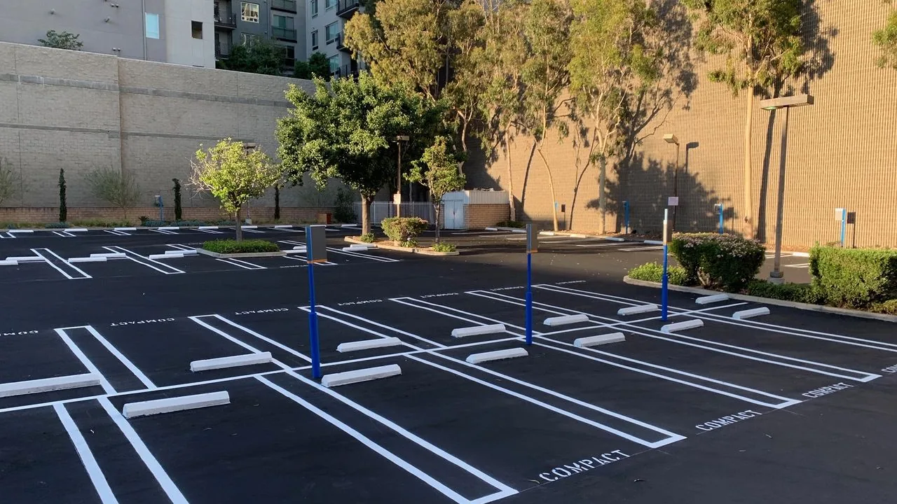 Fresh stall lines and COMPACT stencils in an apartment parking lot