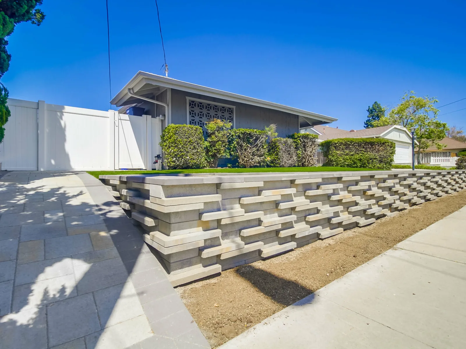 Segmental block retaining wall holding the slope along a driveway, retaining walls