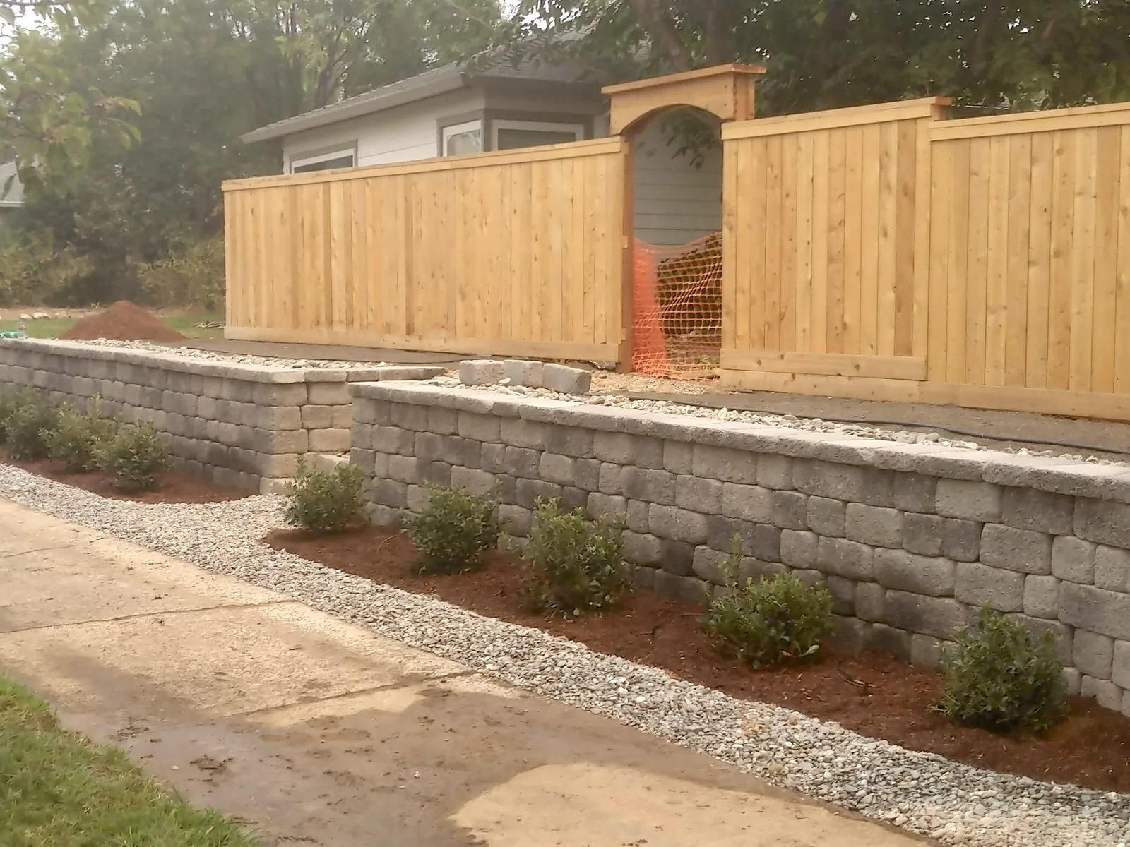 Two tier block wall along a walkway, retaining walls
